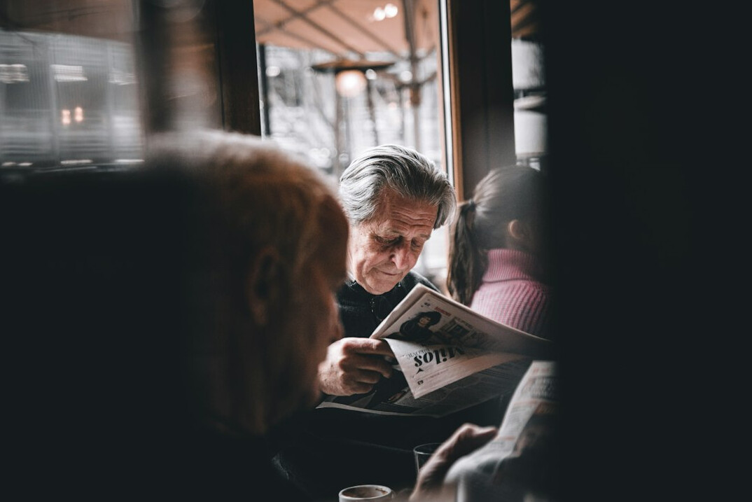 person reading newspaper