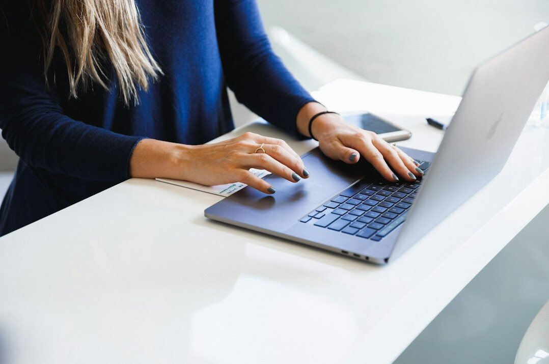 woman reading news on laptop
